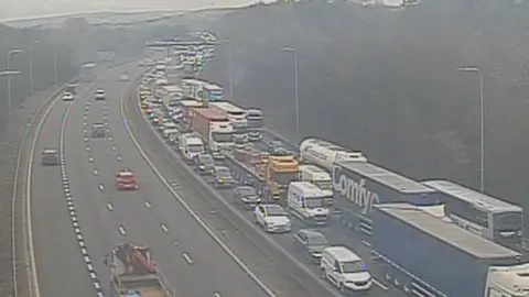 Highways England Long tailbacks on M62 with hills in background