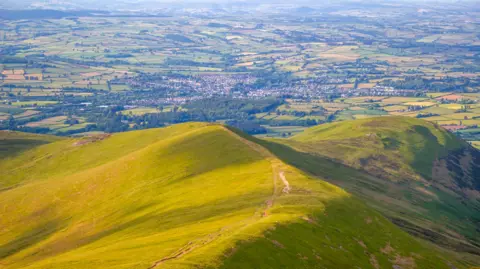 Getty Images A view from a mountain looking down on a town