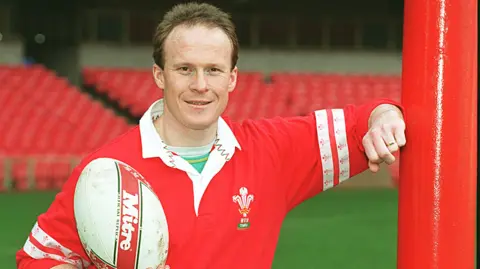 Former Wales international Paul Thorburn poses with a rugby ball in 1996