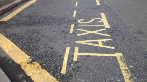 Taxi sign painted on road
