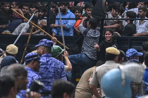 Getty Images Police personnel baton-charge to disperse activists and supporters of the Cockroach Janta Party (CJP) during a protest demanding the resignation of India's Education Minister Dharmendra Pradhan over alleged NEET exam irregularities in New Delhi on July 20, 2026.