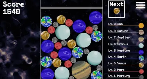 Planet Drop A still from Planet Drop. It has lots of planets piled on top of each other and a scoreboard.