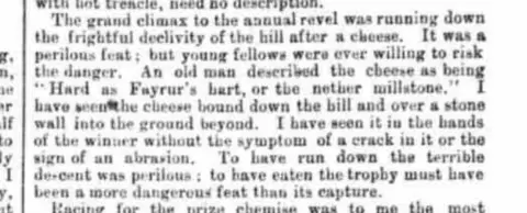 None Close-up of a printed newspaper paragraph describing the dangers of running down Cooper’s Hill after a rolling cheese, with text referring to injuries, stone walls and the risk involved in winning the prize.