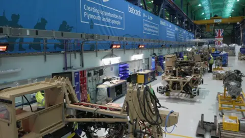 A view of military vehicles being put together in a freeport building