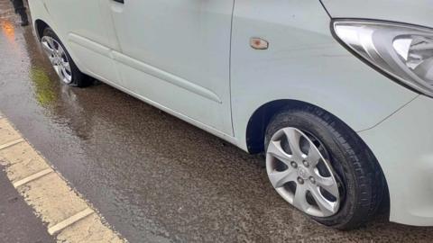 Two tyres on Lynne Davis's car after hitting the pothole 