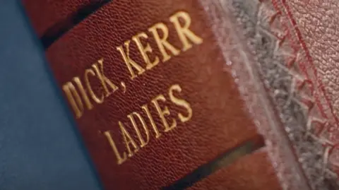 BBC/Ricochet Ltd Gold leaf inscription of Dick, Kerr, Ladies on a brown leather book spine