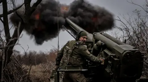 Reuters A Ukrainian soldier fires a gun near Chasiv Yar.