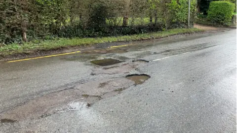 Pothole on road in East Horsley