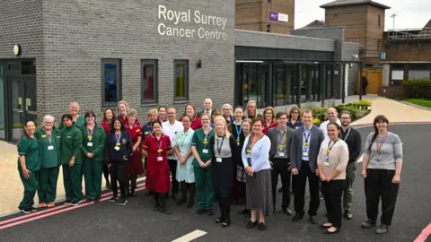 Group of staff stood outside redeveloped cancer centre