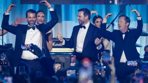  (L-R) Donald Trump Jr., Bettina Anderson, U.S. Vice President-elect JD Vance, and Sergio Gor dance on stage as The Village People perform YMCA during the Turning Point USA Inaugural-Eve Ball at the Salamander Hotel on January 19, 2025 in Washington, DC. Donald Trump will be sworn in as the 47th U.S. president on January 20. 