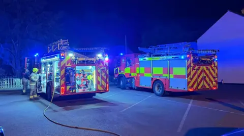 Supplied Two fire appliances on a car park at night
