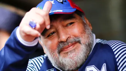 Maradona, aged 59, gesturing a thumbs up before a football match 
