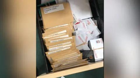 CPS A drawer containing envelopes and football match tickets. They are labelled with match names such as 'Liverpool v Brighton' 