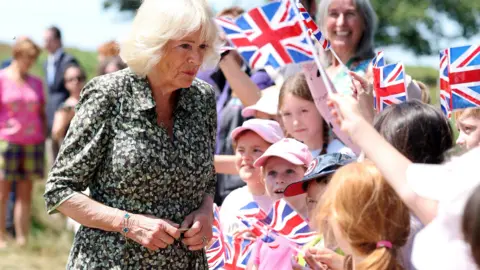 PA Queen Camilla, Patron of the Royal Literary Fund, speaks with local school children during a visit to Ashdown Forest near Hartfield, East Sussex, to commemorate 100 years since the publication of the first Winnie the Pooh book in 1926. Ashdown Forest was the inspiration for the original Hundred Acre Wood and former home of author, A A Milne