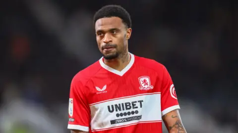 Delano Burgzorg standing on the pitch with his arms by his side during a match for Middlesbrough