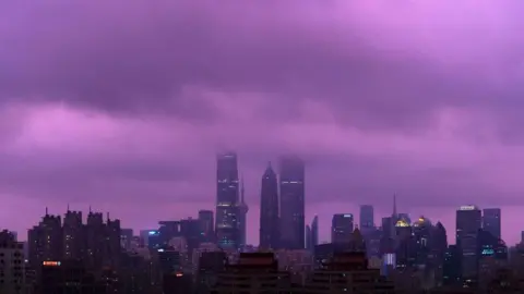 CFOTO/Future Publishing A cityscape of Shanghai's skyscrapers, with the sky and clouds above looking a very rare shade of purple