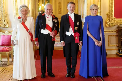 Getty Images Queen Camilla, Emmanuel Macron, King Charles and Brigitte Macron stand in a line as they post for a photo at the state banquet