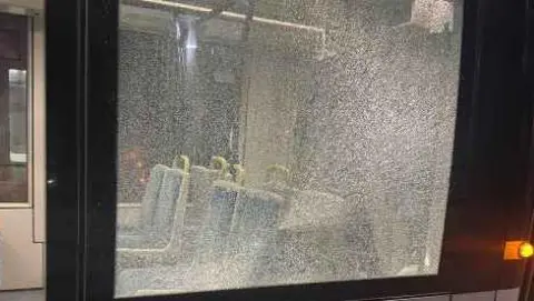 A tram windows that has been shattered
