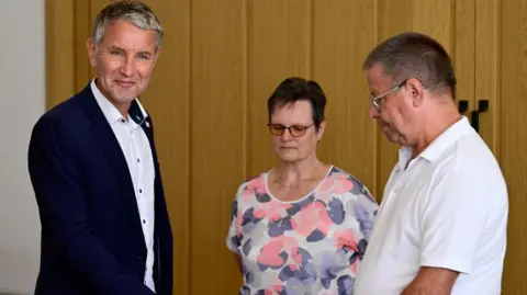 JOHN MACDOUGALL/AFP Top candidate of the far-right AfD (Alternative for Germany) party for regional electios in Thuringia Bjoern Hoecke (L) casts his ballot for Thuringia's regional elections at a polling station in Bornhagen