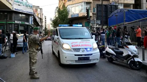 EPA A Lebanese soldier gestures to an ambulance in Beirut (17/09/24)