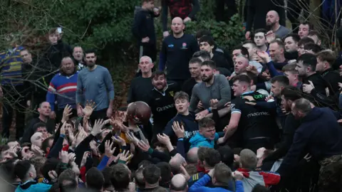 Rex Features Image of people fighting for a ball during Royal Shrovetide Football