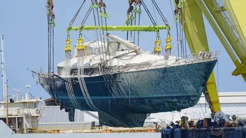 The Bayesian superyacht is moved after being lifted to the surface near the fishing town of Porticello, Sicily