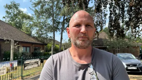 Steve Wilson, the chairman of the Sheerwater Residents Association, looks straight at the camera