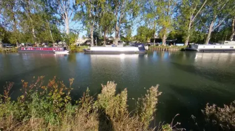 Google Three boats pictured on a river on a clear sunny day