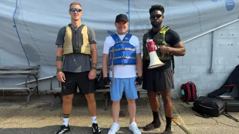 Joe Hart, Wayne Rooney and Micah Richards wearing life jackets