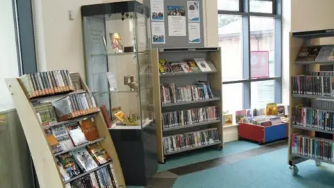 Derby City Council The inside of Springwood Library in Derby, with shelves and displays