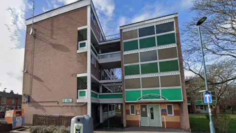 Google Kent House is a five-storey brick block of flats in two sections which are attached by walkways.