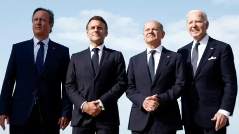 Reuters Foreign Secretary David Cameron, French President Emmanuel Macron, German Chancellor Olaf Scholz and US President Joe Biden