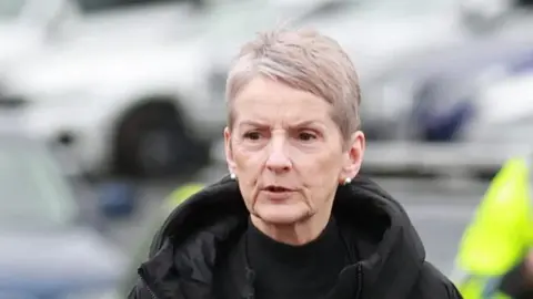 PA Media Lady Eleanor Donaldson arriving at Newry Crown Court. She has short grey hair, wearing a black coat.