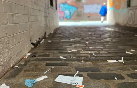 Drug paraphernalia litters a street near Glasgow city centre