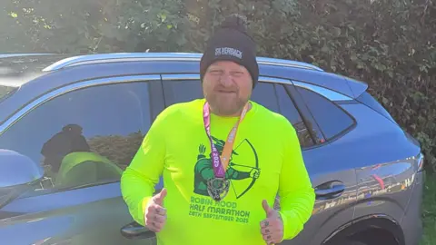 Mark King Mark King with a medal around his neck