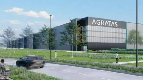 Agratas Architect's image of one of the buildings that will form part of the battery factory site. It is a large grey block with a green lawn out the front. 