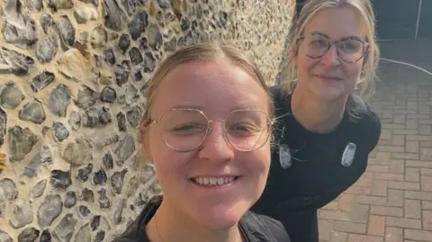 family handout both in dark clothes