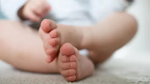 PA Media A close up shot of a baby's feet