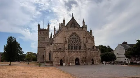 The outside of Exeter Cathedral. The cathedral green is parched after the current drought. 