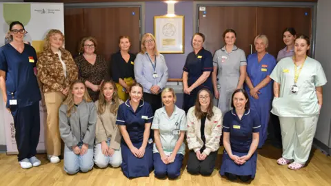 Maternity services staff at Harrogate District Hospital smile for a photo.