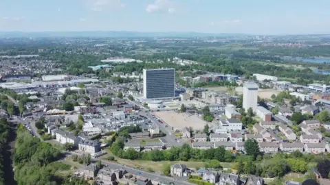 A drone shot of Hamilton town centre, showing the large UN-inspired building that is the HQ of South Lanarkshire Council, and the surrounding area.