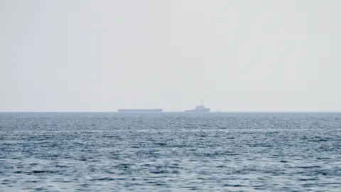 Vessels float in the Strait of Hormuz.