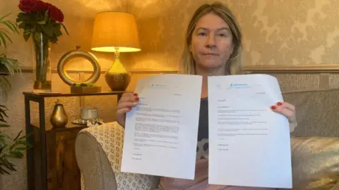 Nicola Stanley holding two letter