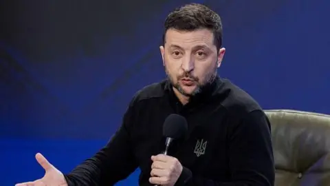 Image shows Ukraine's President Volodymyr Zelensky speaking during a joint press conference on the sidelines of the "Ukraine. Year 2025" forum in Kyiv on 23 February 2025 amid the Russian invasion of Ukraine