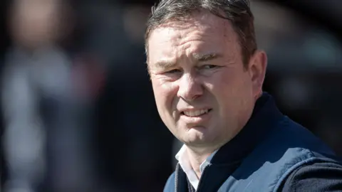 Derek Adams looks on during a Morecambe match