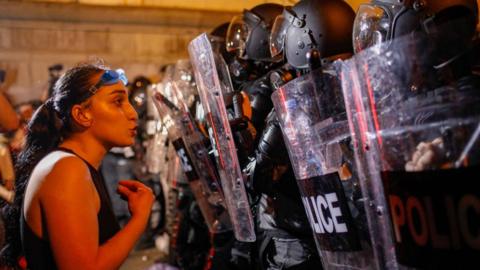 A female protesters confronts riot police in Tbilisi, Georgia. Photo: April 2024