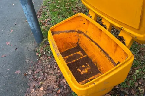 George Torr/BBC An empty yellow grit bin