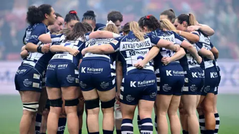 Bristol Bears players huddle on the pitch