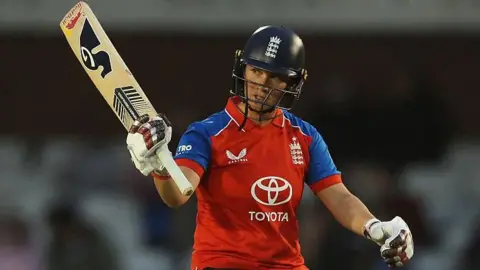 Alice Capsey raises her bat for fifty v New Zealand