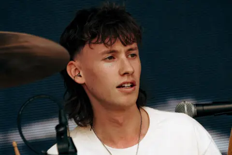 Jack Betts A man playing drums on a stage